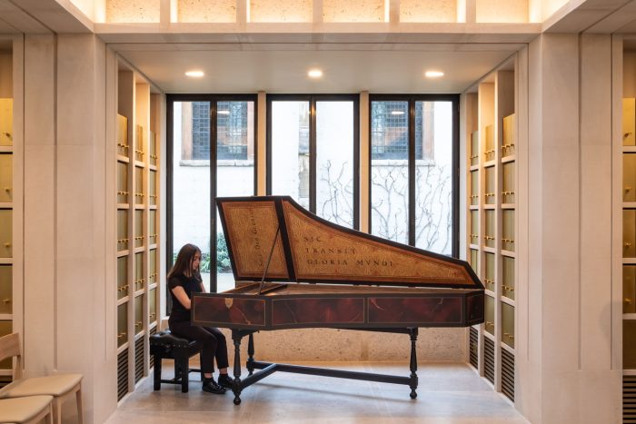Student playing harpsichord in the WongAvery Music Gallery
