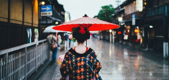 Lady walking in street with parasol