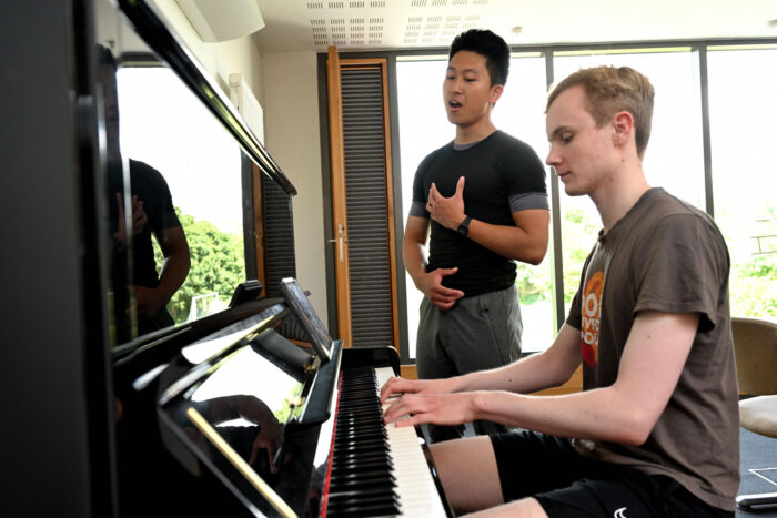 Students at the piano in the David Shephard Room at Wychfield