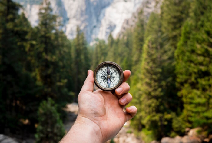 Hand holding compass