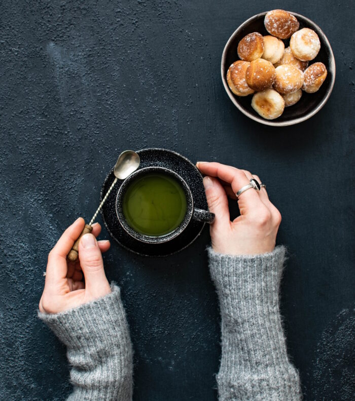 Hands holding a cup of tea