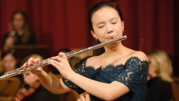 Young woman playing the flute