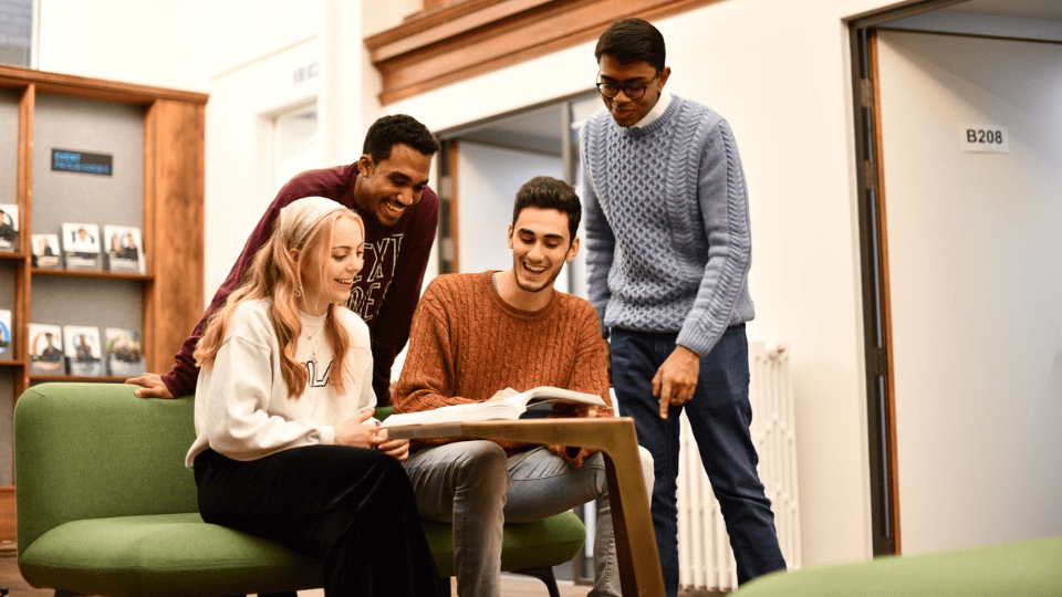 Young professionals gathered around a laptop