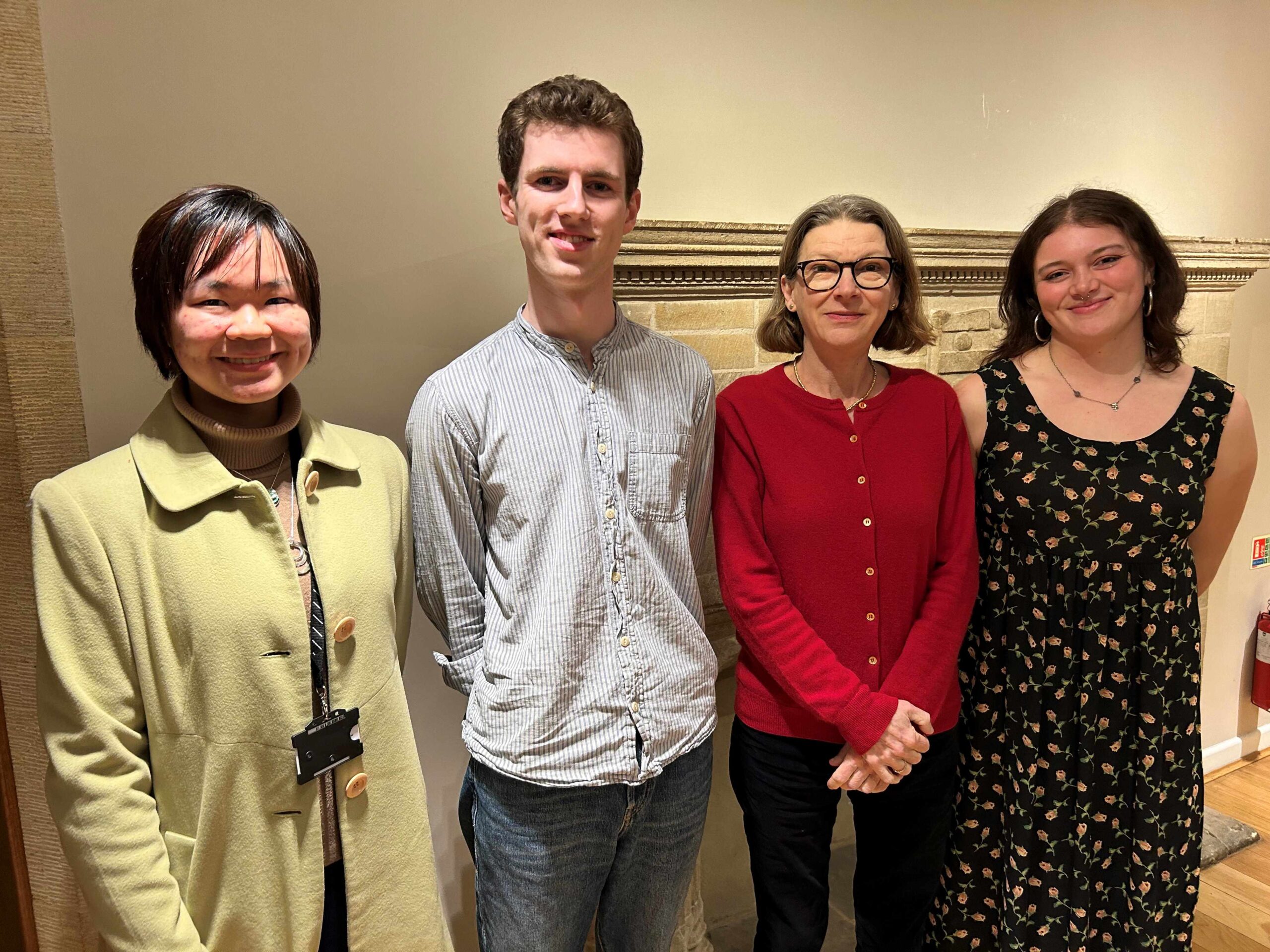 Three prize winners stand with the Master of Trinity Hall, Mary Hockaday