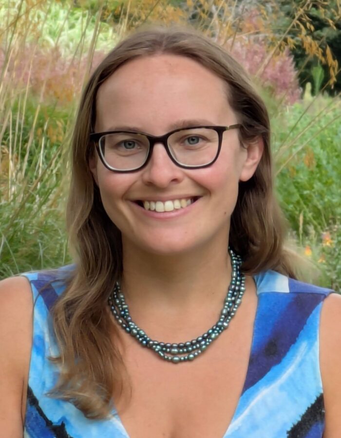 Colour photo of a woman smiling at the camera.