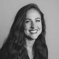 Black & White photograph of a woman smiling at the camera.