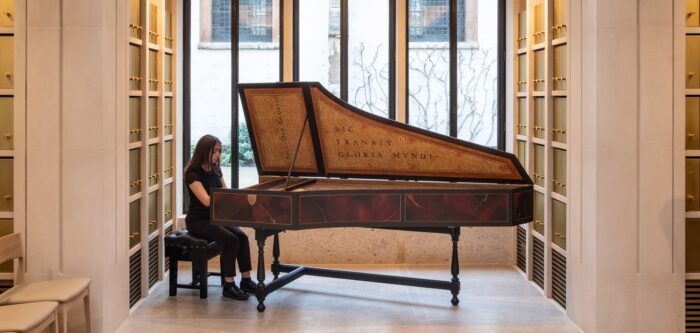 Student playing harpsichord in the WongAvery Music Gallery