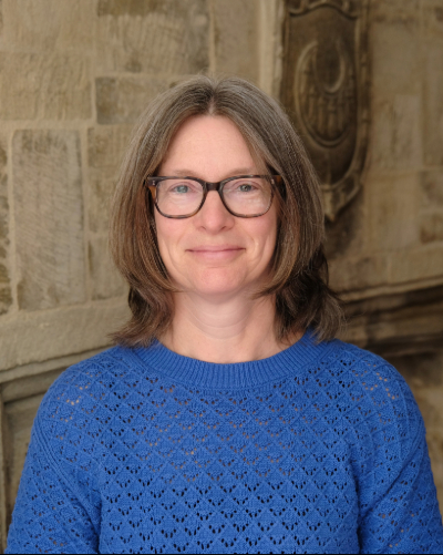 Liz Pentlow pictured in front of a Trinity Hall crescent in the Robin Hayes room.