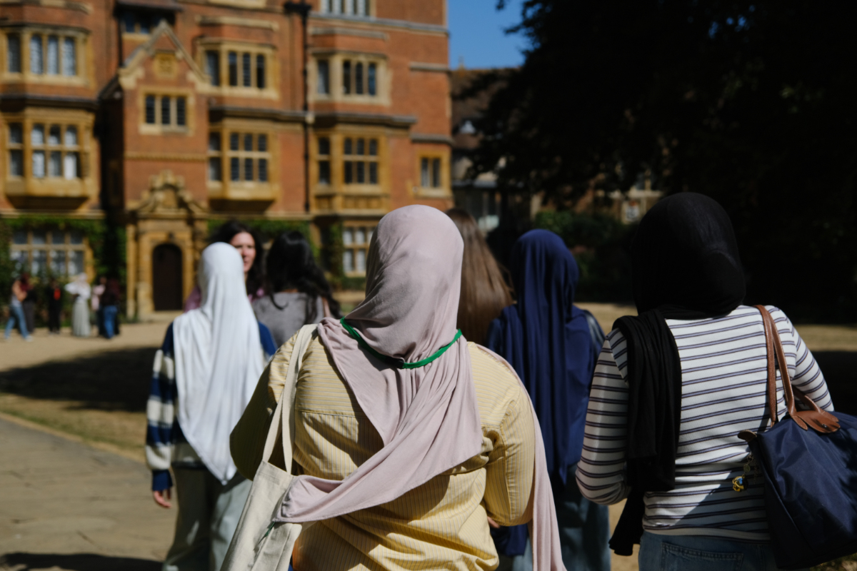 A student ambassador shows a group of You'll Fit In students around Trinity Hall
