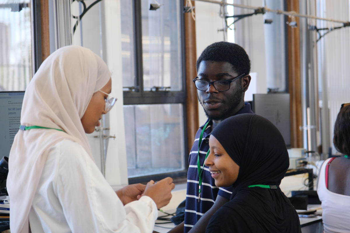A group of You'll Fit In students chatting during a lab visit.