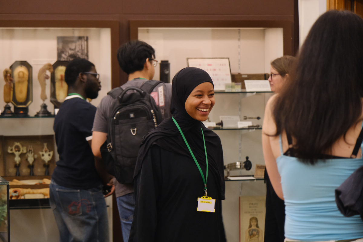 A group of You'll Fit In students looking at displays of historic scientific instruments atthe Whipple Museum of the History of Science